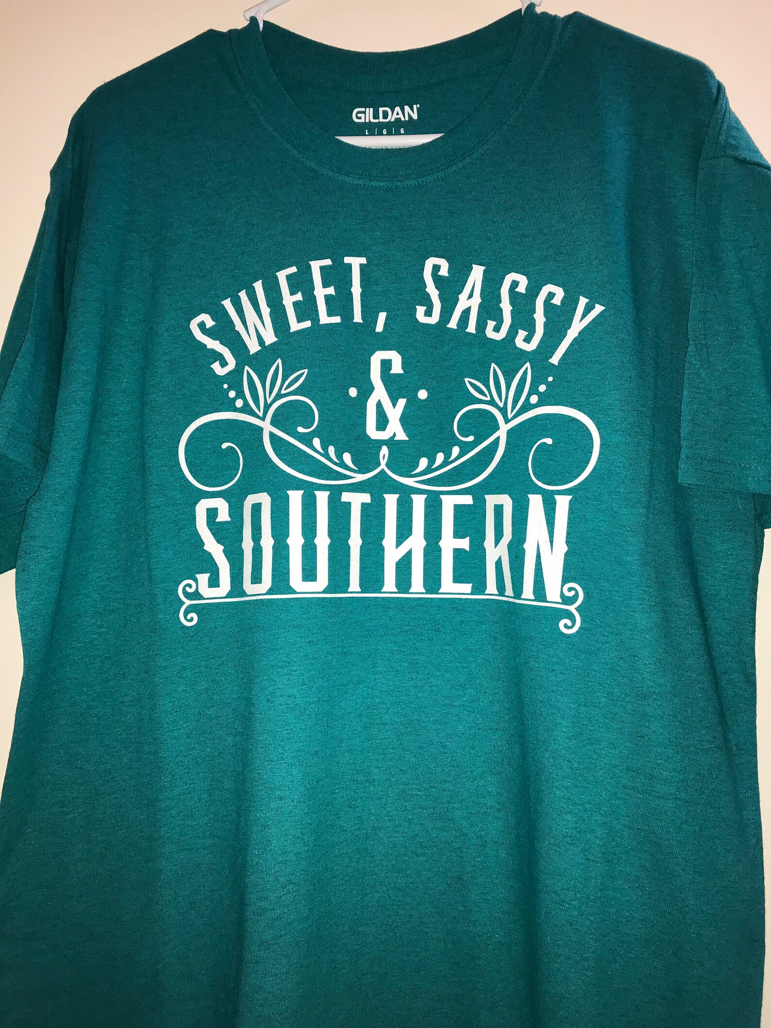 teal shirt with white writing
