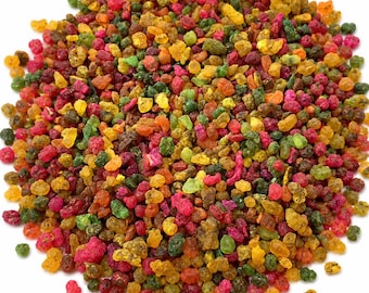 May include: A pile of colorful, small, irregularly shaped pieces. The pieces are a mix of red, green, yellow, orange, and brown. The image is taken against a white background.
