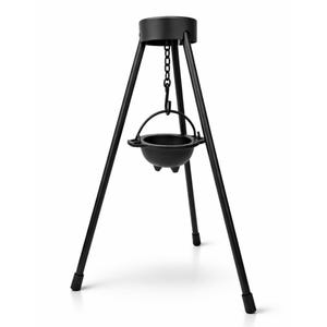 May include: A black cast iron cauldron hanging from a tripod stand. The cauldron has three small feet and a handle. The tripod has three legs and a circular top. The stand and cauldron are black.