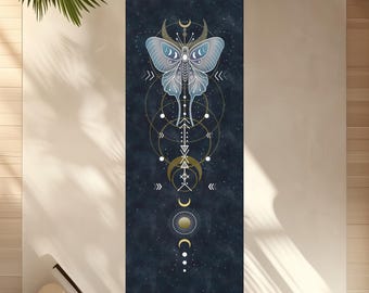 May include: A rectangular yoga mat with a dark blue background and a celestial butterfly design. The butterfly is light blue with gold accents, and the mat features a series of geometric shapes and the text "Comfy YOGA".