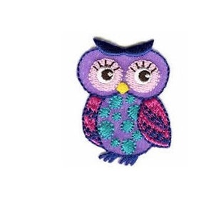 May include: Purple and pink embroidered owl applique with teal and blue accents. The owl has large, round eyes and a small yellow beak.