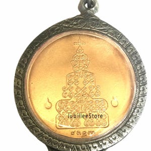 Könnte beinhalten: Ein goldener Anhänger mit einem silbernen Rahmen und einem detaillierten Design einer Buddha-Figur. Der Anhänger ist an einer goldenen Kette.