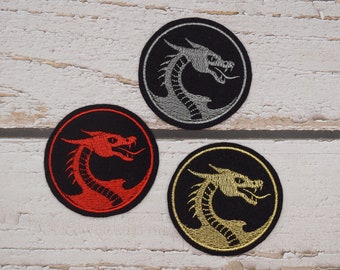 Small button dragon in desired color (109 colors to choose from) on black felt, patch application embroidered patch