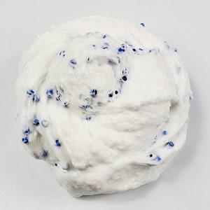 May include: White slime with blue beads mixed in. The slime is in a large, round mound.