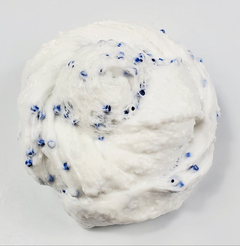 May include: White slime with blue beads mixed in. The slime is in a large, round mound.