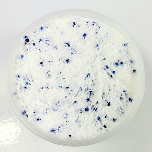 May include: White slime with blue flecks in a clear plastic container.