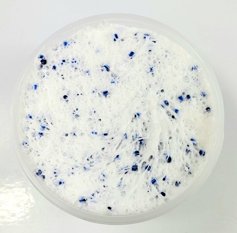 May include: White slime with blue flecks in a clear plastic container.