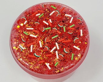 May include: Red glitter slime with watermelon and white sprinkles.