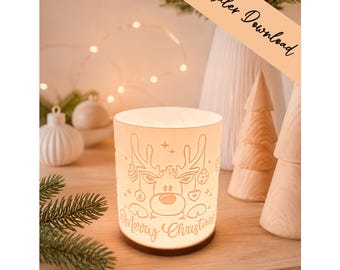 May include: A cylindrical white lamp shade featuring a line art illustration of a reindeer with antlers, hanging ornaments, and the text Merry Christmas. The shade has a warm internal glow and sits on a dark circular base with a smooth finish.