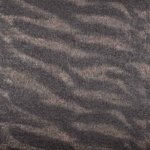 Può includere: Primo piano di un tessuto strutturato con un motivo a onde nei toni del grigio e del marrone. Il tessuto ha un aspetto morbido e vellutato. Un righello con segni in centimetri è visibile nella parte inferiore dell'immagine.