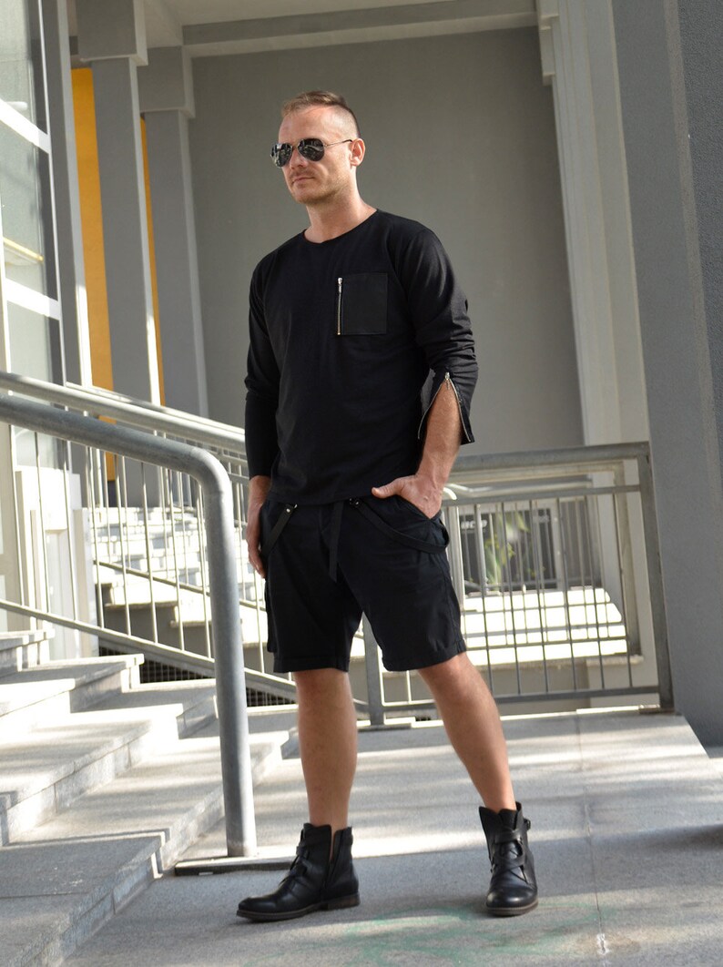 black sweatshirt with zip pocket and zippered cuff