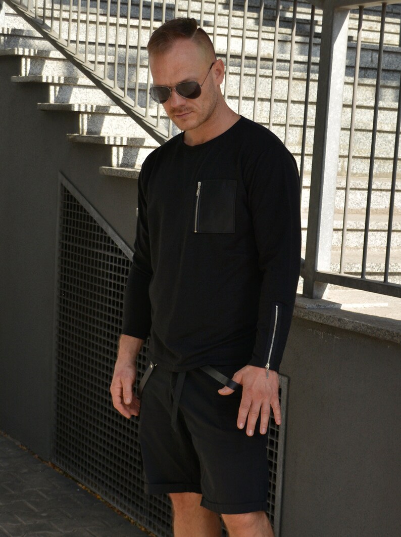 black sweatshirt with zip pocket and zippered cuff