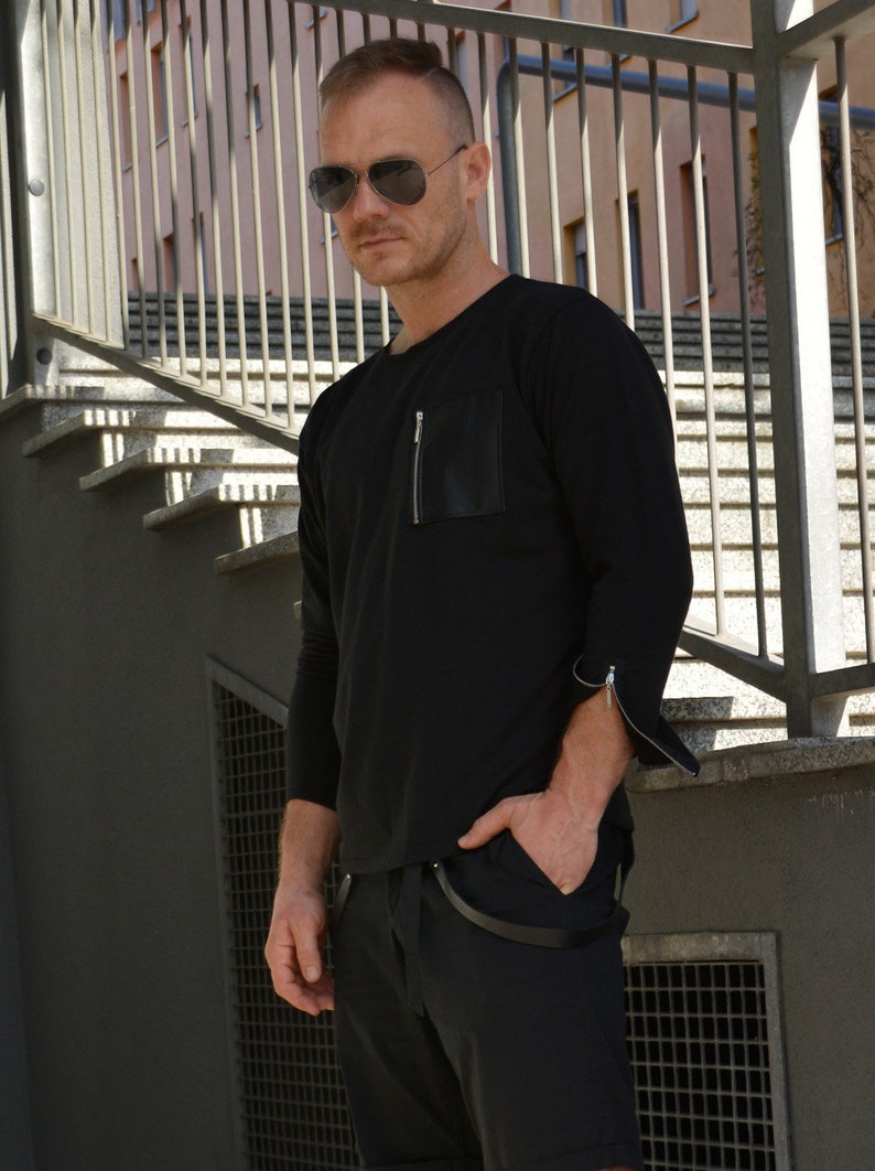 black sweatshirt with zip pocket and zippered cuff