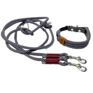 May include: A gray and white rope dog leash with a red accent and two silver clips. A matching gray and white rope collar with a brown leather accent and silver buckle is also included.