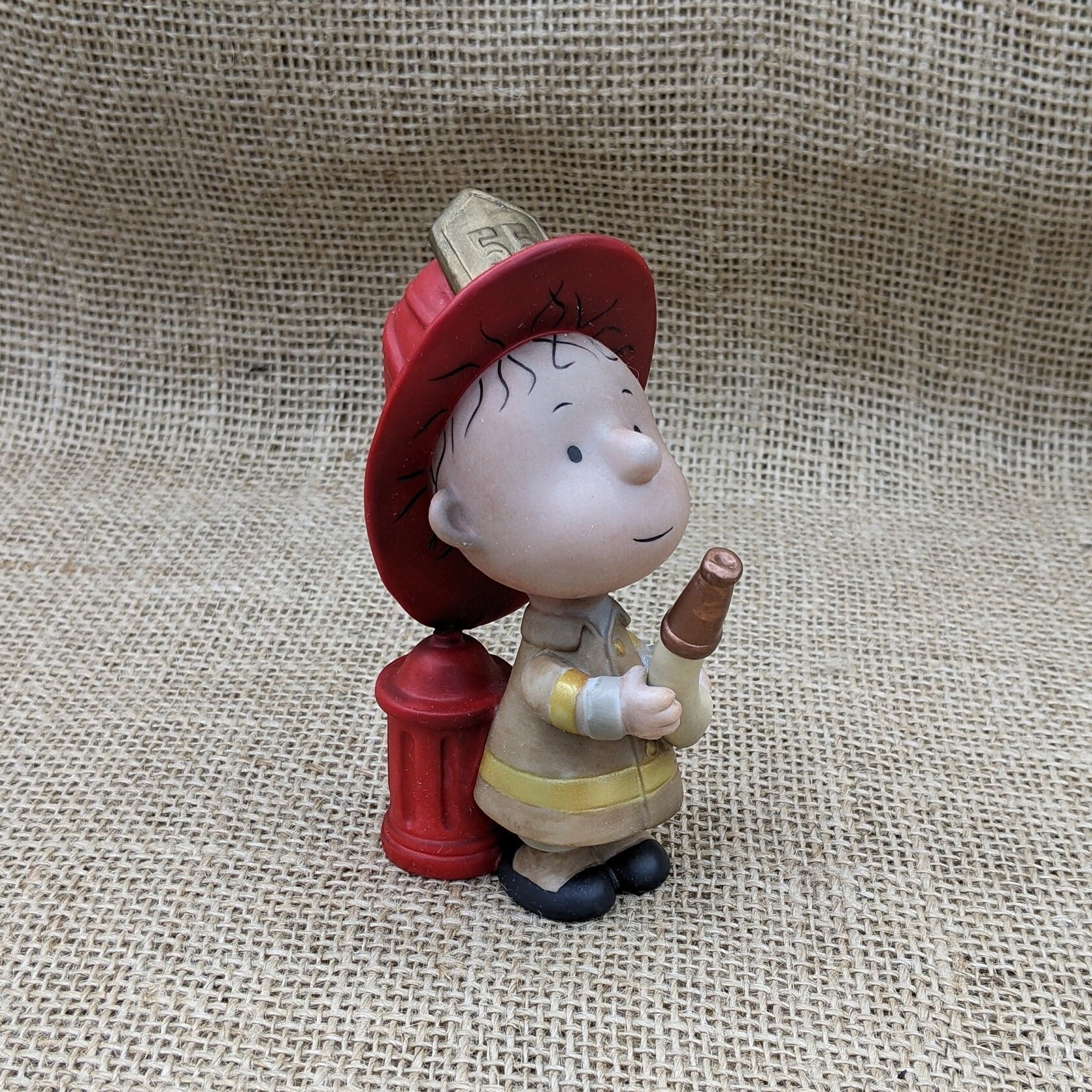 Fire fighter Pigpen, Peanuts figurine, Hallmark Peanuts Gallery, Pigpen in firefighter uniform with hose and hydrant, 2001, signed numbered Fire fighter Pigpen, Peanuts figurine, Hallmark Peanuts Gallery, Pigpen in firefighter uniform with hose and hydrant, 2001, signed numbered