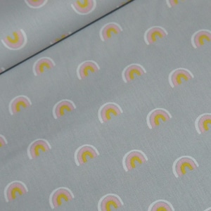 May include: A grey fabric with a repeating pattern of small pink, yellow and white rainbows.