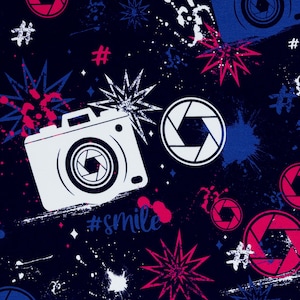 May include: A dark blue background with a repeating pattern of white camera silhouettes, red and blue starbursts, and white paint splatters. The text "#smile" appears twice in the pattern.
