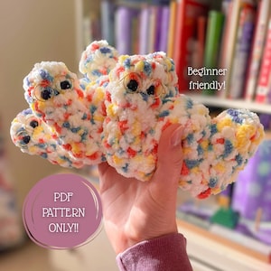 May include: A plush, multi-colored yarn creature with white, blue, yellow, and red flecks, featuring black plastic eyes and small gold-toned wire glasses. The image includes the text 'Beginner friendly!' and 'PDF PATTERN ONLY!!' in a circular frame.