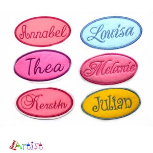 May include: Embroidered name patches in various colors, including pink, blue, and yellow. Each patch features a different name in a cursive font: Annabel, Louisa, Thea, Melanie, Kerstin, and Julian. The patches are oval-shaped.