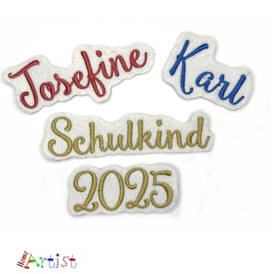May include: Four embroidered patches with white felt backing. The patches are gold, red, and blue. The patches read "Josefine", "Karl", "Schulkind", and "2025".