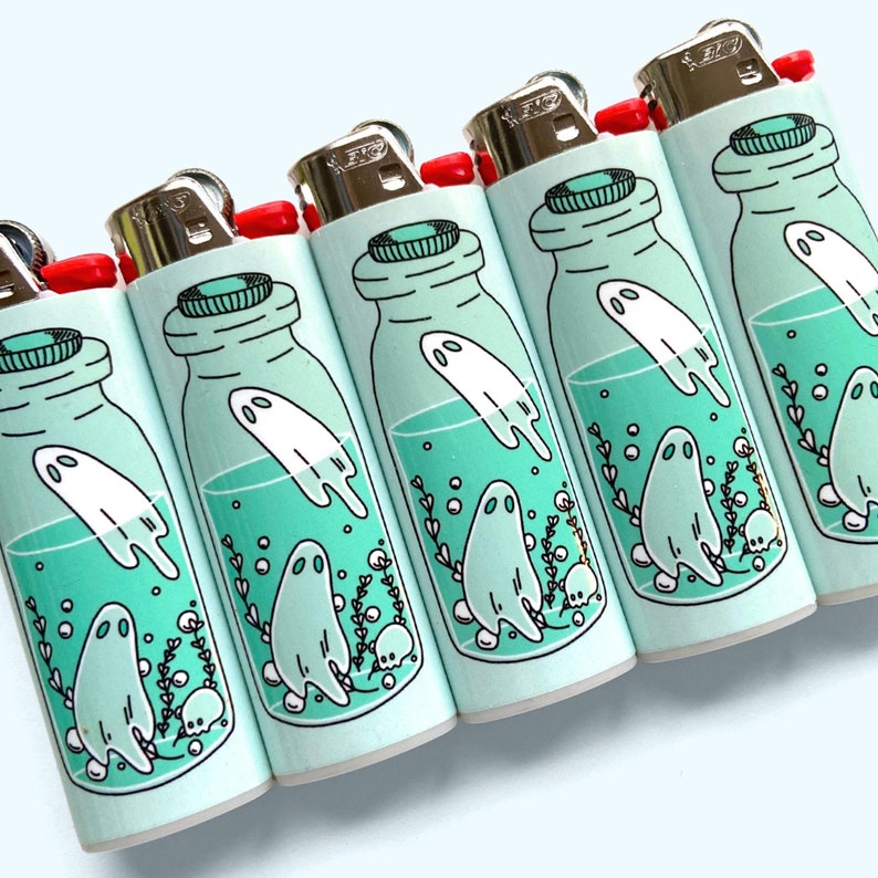 Puede incluir: Conjunto de seis encendedores azul turquesa con un gr&aacute;fico de un fantasma en una botella. Cada botella tiene una pose de fantasma diferente y est&aacute; rodeada de burbujas y algas marinas.