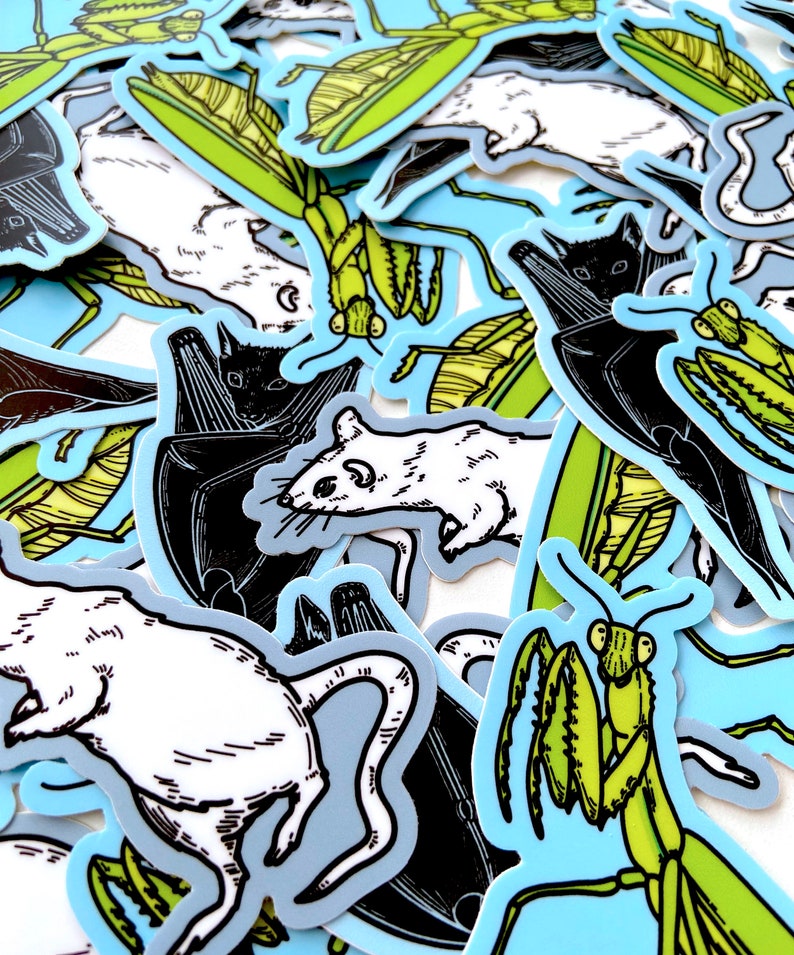 May include: A collection of stickers featuring black and white illustrations of rats, bats, and praying mantises. The stickers are outlined in blue and have a light blue background.