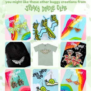 May include: A collection of bug-themed earrings, a t-shirt, and a beanie hat. The earrings feature a variety of insects, including moths, snails, and ladybugs. The t-shirt has a moth design and the beanie hat has a moth design. The text "Spooky Doodle Club" appears on each of the cards.
