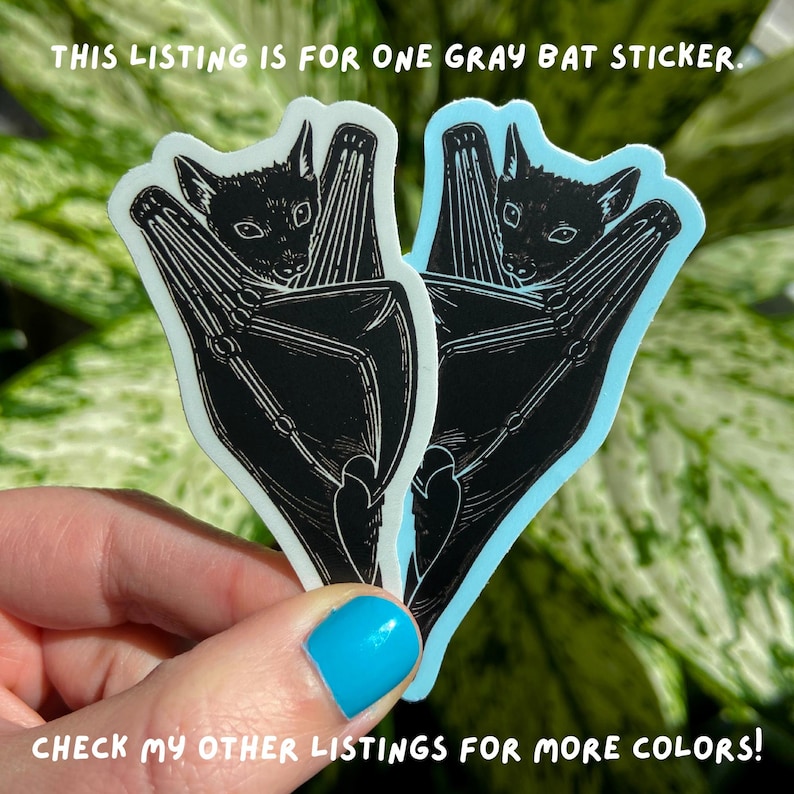 May include: Two gray bat stickers with a black silhouette of a bat with its wings folded around its body. The text "THIS LISTING IS FOR ONE GRAY BAT STICKER." is at the top of the image. The text "CHECK MY OTHER LISTINGS FOR MORE COLORS!" is at the bottom of the image.
