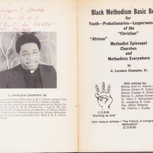 May include: An open book with text and a black and white photo of G. Lovelace Champion, Sr. The text includes "Black Methodism Basic Beliefs" and the names of contributors. The book is on a white background.