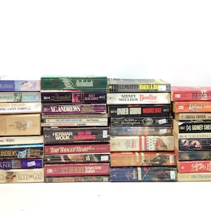 May include: A collection of hardcover books with various titles and authors. The spines display titles like "Redeye," "Nothing Lasts Forever," and "Under Ground." The books are stacked in multiple rows against a white background.