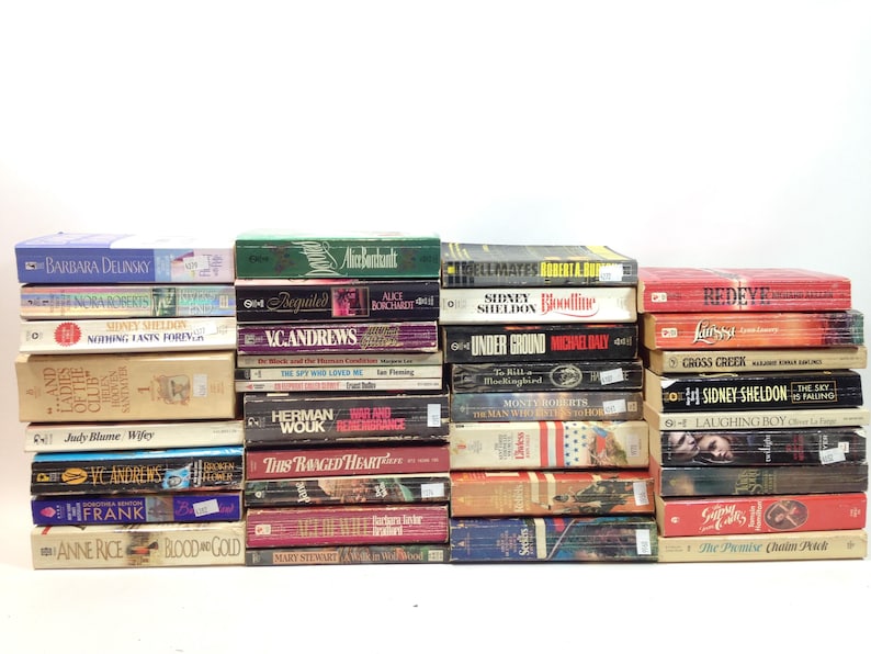 May include: A collection of hardcover books with various titles and authors. The spines display titles like "Redeye," "Nothing Lasts Forever," and "Under Ground." The books are stacked in multiple rows against a white background.