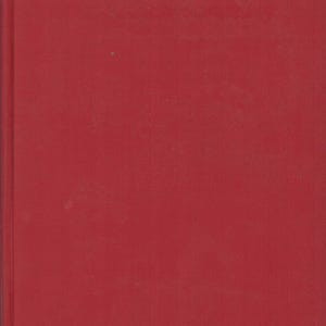 May include: A solid red book cover with a vertical spine edge visible on the left side. The surface is a uniform, deep red color with a subtle texture, showing no text, graphics, or illustrations on the front panel of the rectangular object.