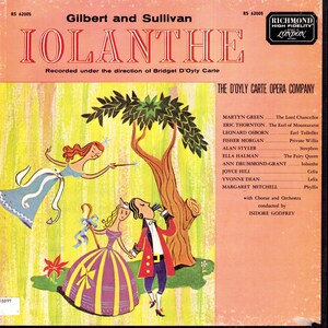 May include: A vintage vinyl record sleeve for Gilbert and Sullivan's Iolanthe, featuring a colourful illustration of a fairy, a woman in a striped dress, and a man in a red coat. The text includes the title, cast list, and conductor name.