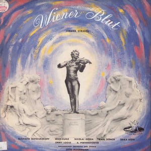May include: Vintage vinyl record album cover for "Wiener Blut" by Johann Strauss. The cover features a statue of a man playing a violin, surrounded by abstract brushstrokes in blue, red, and yellow. The album title and artist's name are in elegant script.