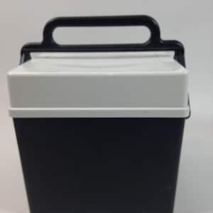 May include: A portable cooler with a solid black rectangular base and a contrasting white lid. The cooler features a sturdy black plastic handle attached to the top, designed for easy carrying. The overall design is simple, functional, and compact.
