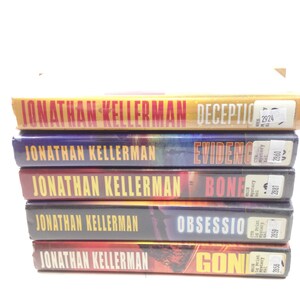 May include: A stack of five hardcover books by Jonathan Kellerman. The book titles include "Deception", "Evidence", "Bone", "Obsession", and "Gone". The book covers feature various colors, including yellow, purple, red, and orange.
