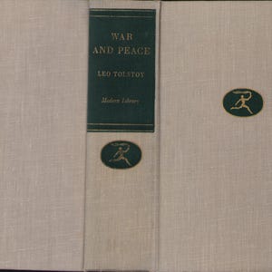 May include: A hardcover book titled "War and Peace" by Leo Tolstoy. The book has a light beige linen cover with a dark green spine. The spine features the title, author, and publisher. A gold emblem is on the front cover.