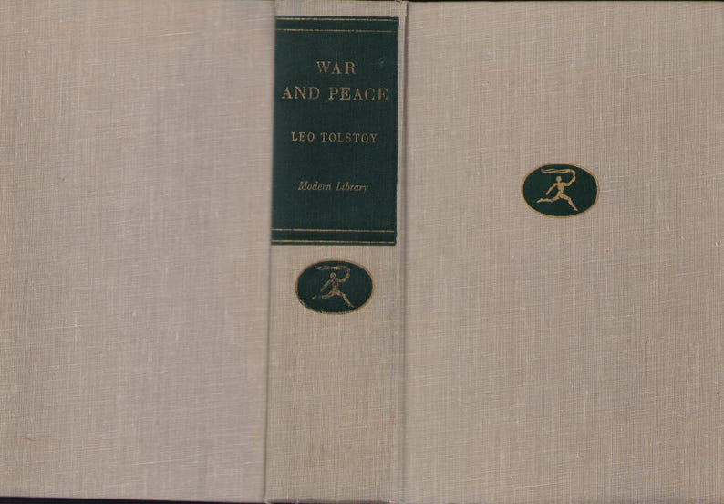 May include: A hardcover book titled "War and Peace" by Leo Tolstoy. The book has a light beige linen cover with a dark green spine. The spine features the title, author, and publisher. A gold emblem is on the front cover.