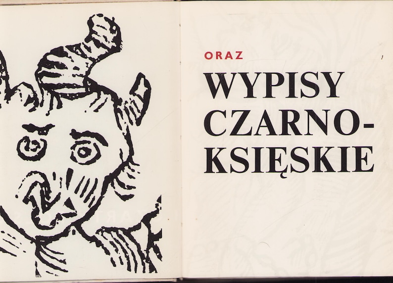 May include: An open book with a black and white illustration of a horned creature on the left page. The right page has the word "ORAZ" in red, and the title "WYPISY CZARNO-KSIĘSKIE" in black.