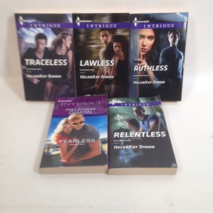 May include: Five paperback books with purple and white covers. The books are part of a series called "Intrigue" and feature the text "Traceless", "Lawless", "Ruthless", "Fearless", and "Relentless". Each book has a different cover image featuring a couple in a dramatic pose.