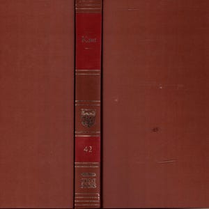 May include: A brown hardcover book with a red spine. The spine displays the title "Kant" in gold lettering, the number "42", and the words "Great Books". The book has a classic, vintage appearance, suggesting a historical or literary theme.