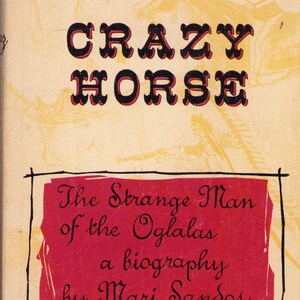 May include: Vintage book cover for "Crazy Horse" by Mari Sandoz. The cover features the title in large, black letters with red accents. The book's title is above a red rectangle with the book's subtitle and author's name.