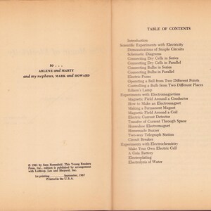 May include: Open book pages with text. The left page has a dedication to Arlene and Marty, and nephews Mark and Howard. The right page is a table of contents for a book on electricity, with chapter titles and page numbers.