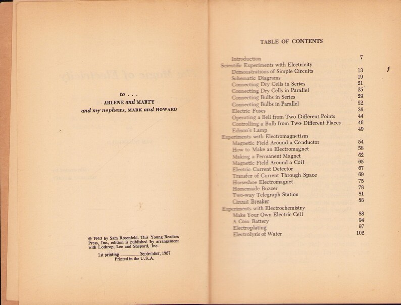 May include: Open book pages with text. The left page has a dedication to Arlene and Marty, and nephews Mark and Howard. The right page is a table of contents for a book on electricity, with chapter titles and page numbers.