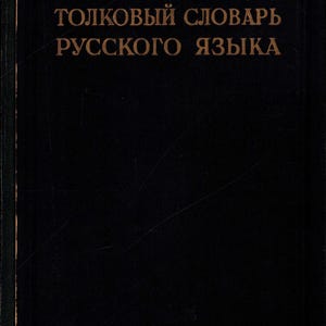 Peut inclure: Un livre noir ancien avec des lettres dorées. Le titre, en russe, est "Dictionnaire explicatif de la langue russe". La couverture est simple, avec une apparence légèrement usée, suggérant l'âge et l'utilisation. Le texte est centré sur la couverture.