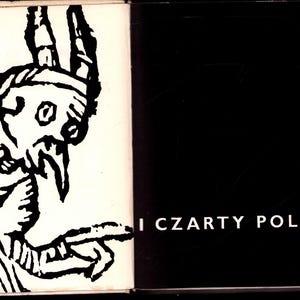 May include: Open book with a black and white illustration of a horned figure with a long beard and pointed finger. The text "I CZARTY POLSKIE" is printed in white on the right page. The book has a black background.