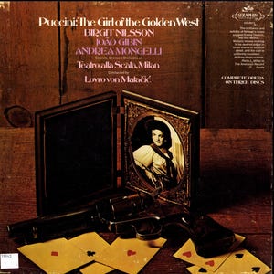 May include: A vinyl record cover for Puccini: The Girl of the Golden West featuring Birgit Nilsson, João Gibin, and Andrea Mongelli. The cover displays a black revolver, playing cards, and an ornate gold-framed portrait of a woman in a hat.