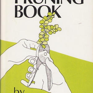 May include: The book cover for The Pruning Book by Gustave L. Wittrock features a black and white line drawing of hands using pruning shears to cut a small green leafy branch against a white and lime green background.