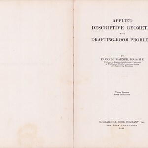 May include: An open book with the title "APPLIED DESCRIPTIVE GEOMETRY with DRAFTING-ROOM PROBLEMS" by Frank M. Warner. Published in 1940 by McGraw-Hill Book Company, this is the third edition. The pages are off-white with black text.
