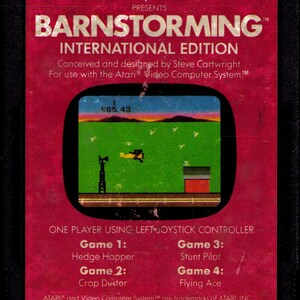 May include: Vintage Atari video game cartridge for Barnstorming, an Activision game. The red cartridge features the game's title, a retro game screen, and game descriptions. The game is for the Atari Video Computer System.